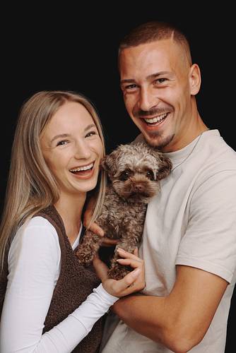 Couple portrait with dog in a photo studio